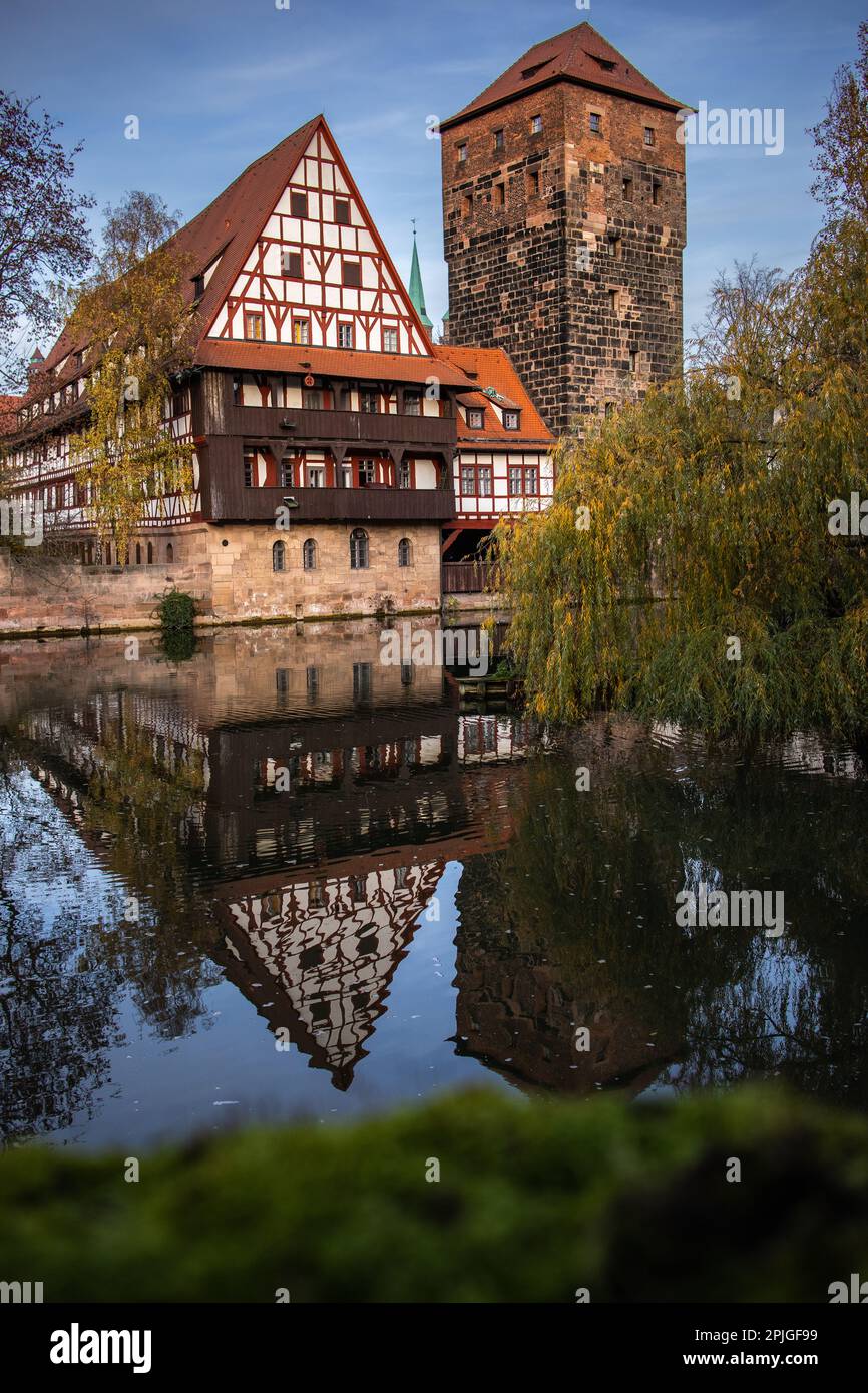 Vertical Water Reflection of Weinstadel in Germany. Old Building with Water Tower and River Pegnitz in Autumn Nuremberg. Stock Photo