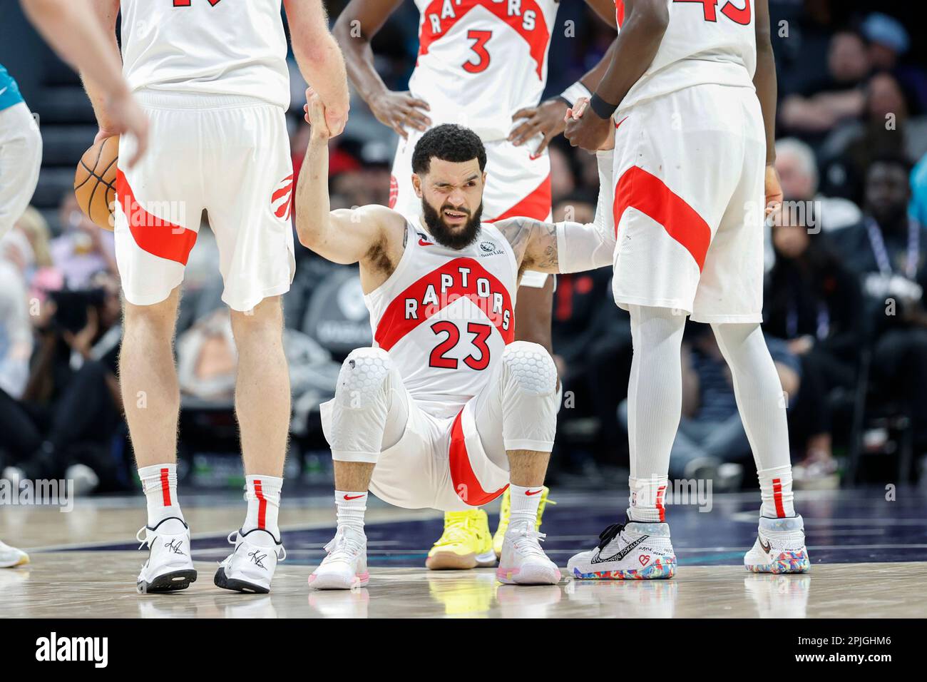 Toronto Raptors guard Fred VanVleet (23) grimmaces as he is helped up
