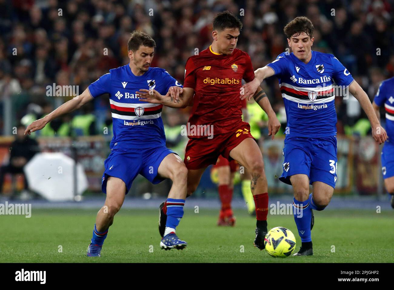 Rome, Italy. 02nd Apr, 2023. Paulo Dybala, center, of AS Roma, is challenged by Filip Djuricic, left, and Flavio Paoletti, of Sampdoria, during the Serie A football match between Roma and Sampdoria at Rome's Olympic stadium, Rome, Italy, April 2, 2023. Credit: Riccardo De Luca - Update Images/Alamy Live News Stock Photo