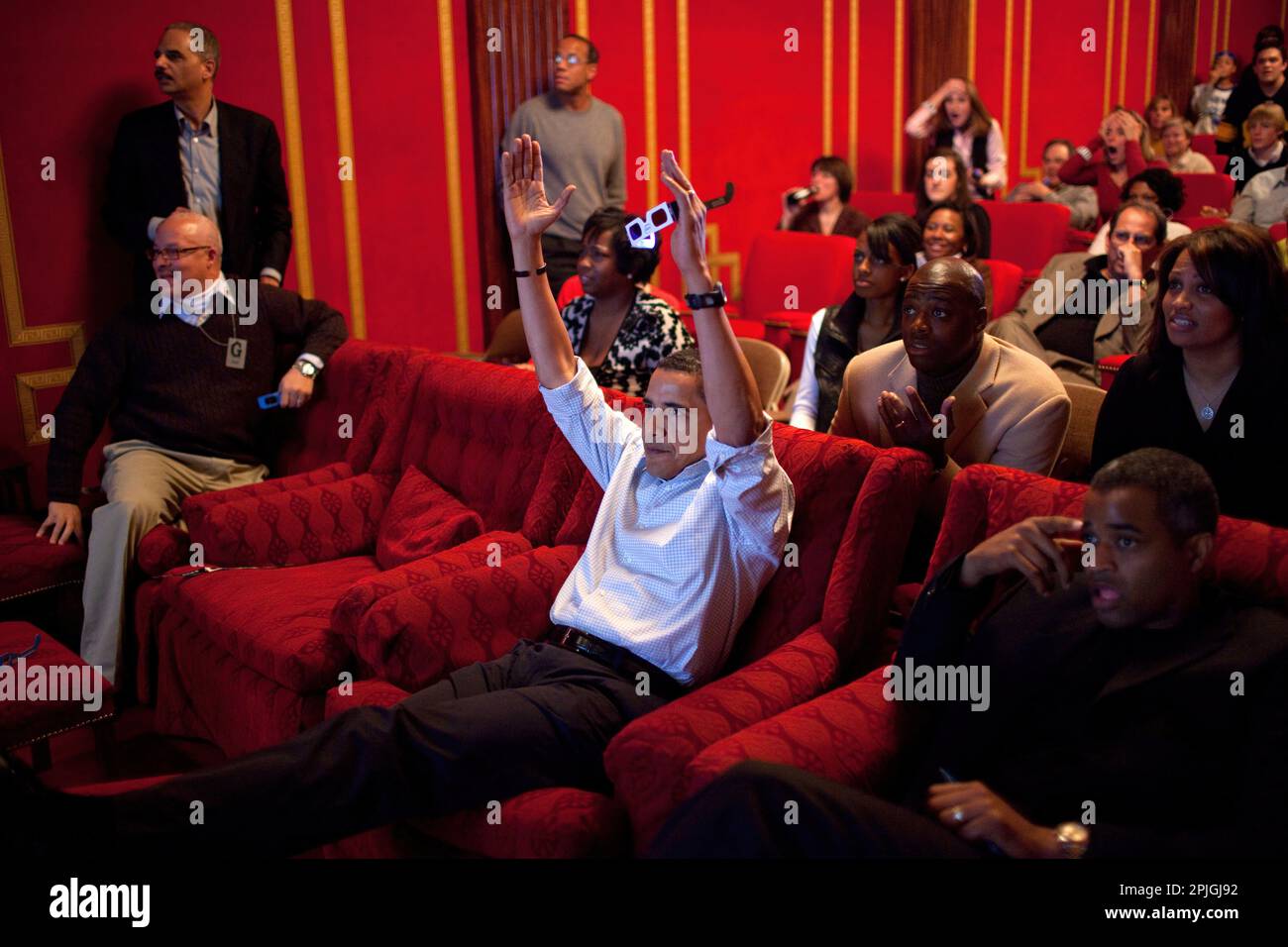 President Barack Obama holds 3-D glasses while watching the Super Bowl game at a Super Bowl Party in the family theater of the White House. Guests included family, friends, staff members and bipartisan members of Congress, 2/1/09. .Official White House Photo by Pete Souza Stock Photo