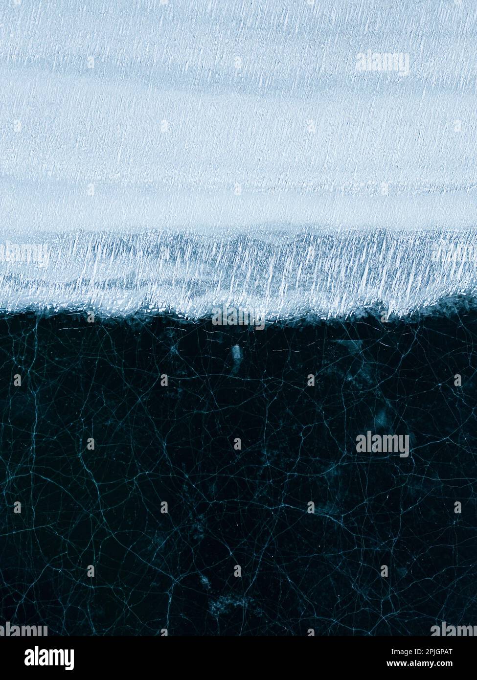 Vertical aerial shot of patterns on sea ice in Iceland Stock Photo