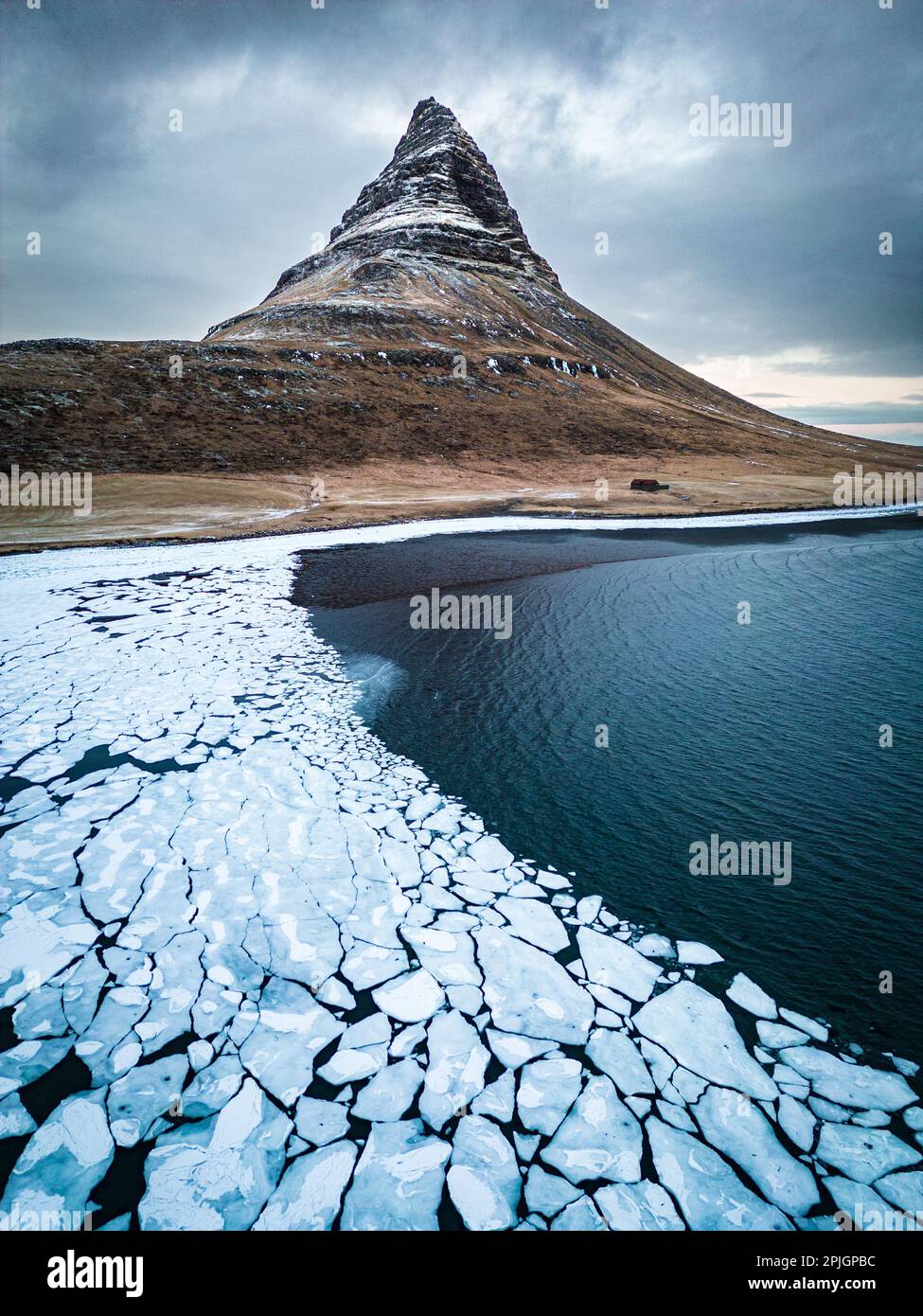 Kirkjufell mountain in winter with frozen sea ice Stock Photo - Alamy
