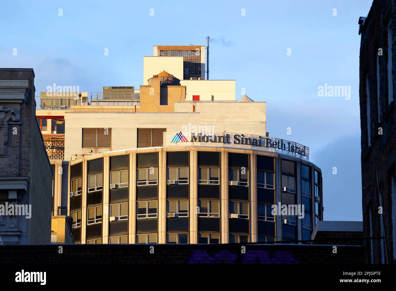 Mount Sinai Beth Israel hospital framed by adjacent buildings. At 281 First Ave, New York. Stock Photo