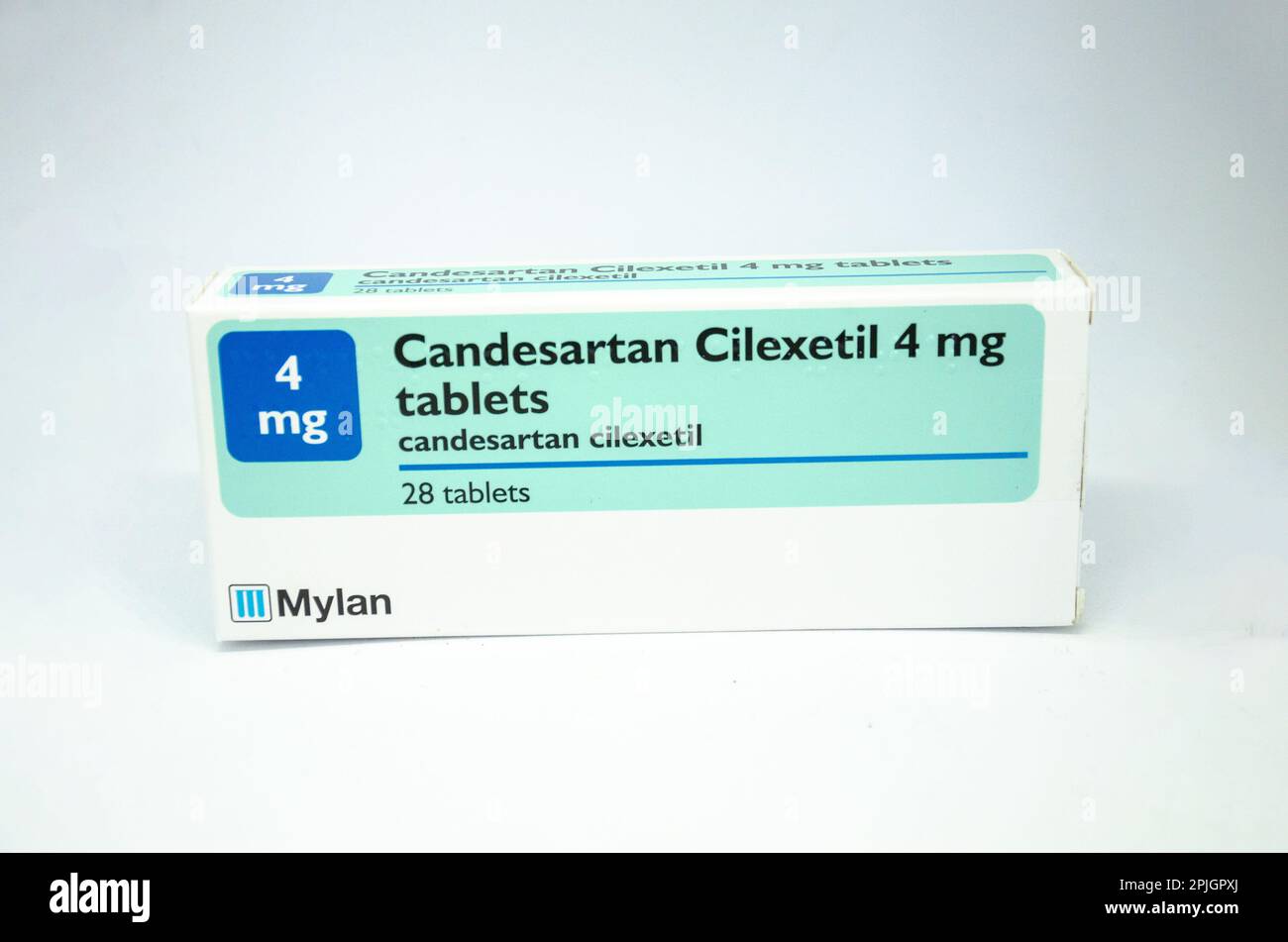 A box of 4mg Candesartan cilexetil tablets in a box isolated against a white background, is used to treat hypertension and hear related conditions Stock Photo