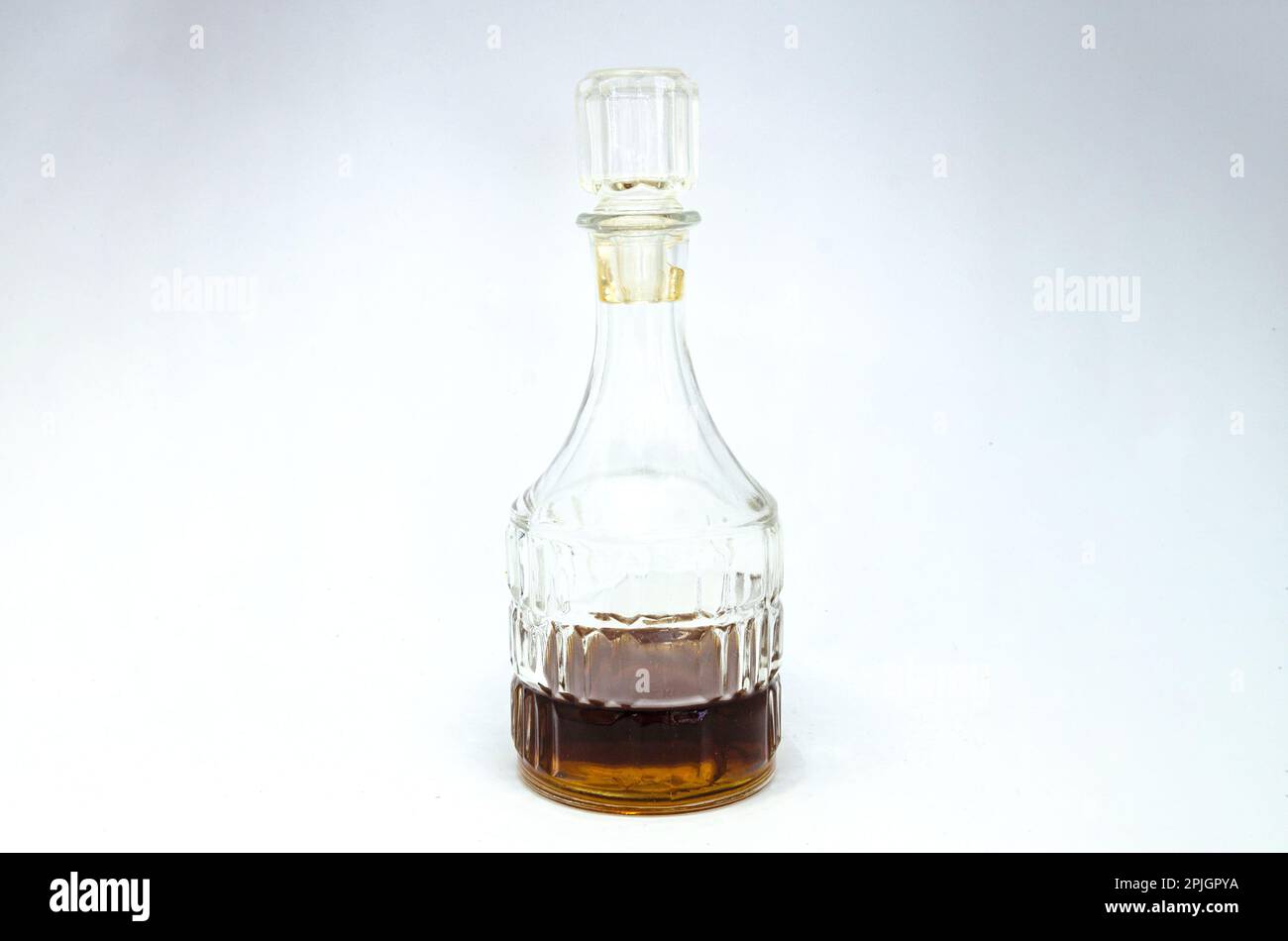 A vinegar bottle containing malt vinegar isolated against a white