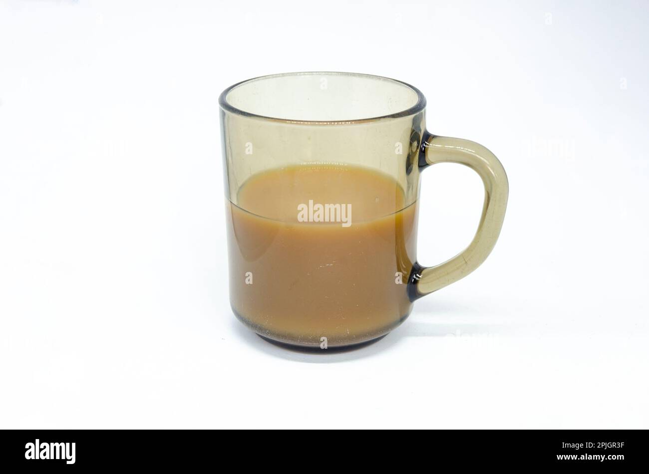 A mug of tea in a glass mug isolated against a white background. Stock Photo