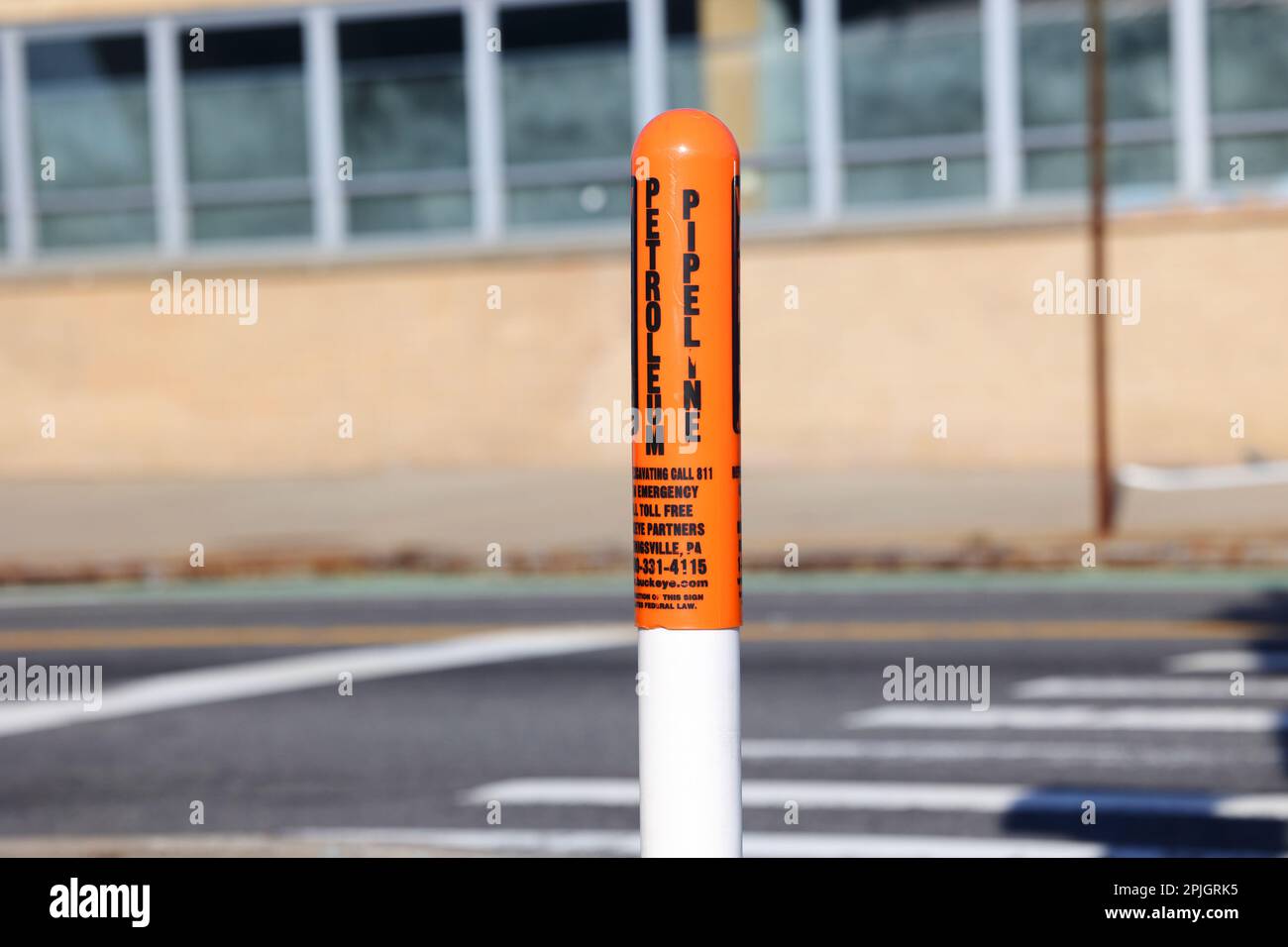An orange capped Petroleum Pipeline marker post Stock Photo