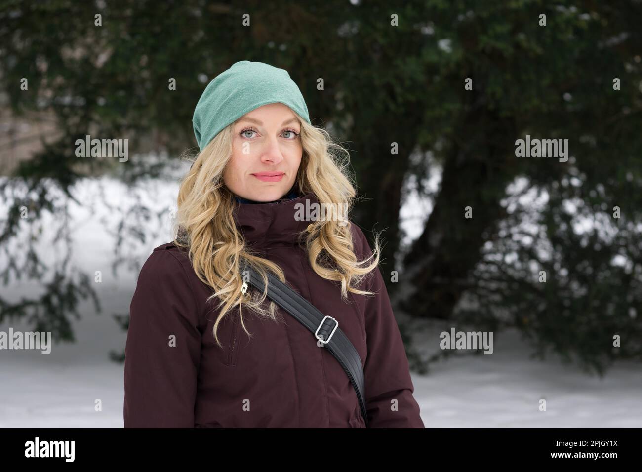 blond woman wearing warm winter fashion and woolen hat Stock Photo