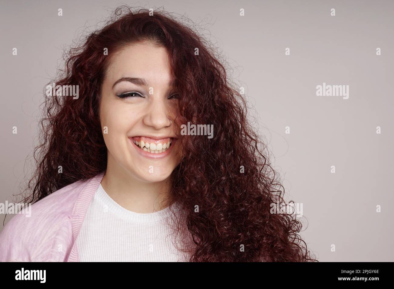 happy teenage girl with long curly hair and a big smile Stock Photo - Alamy