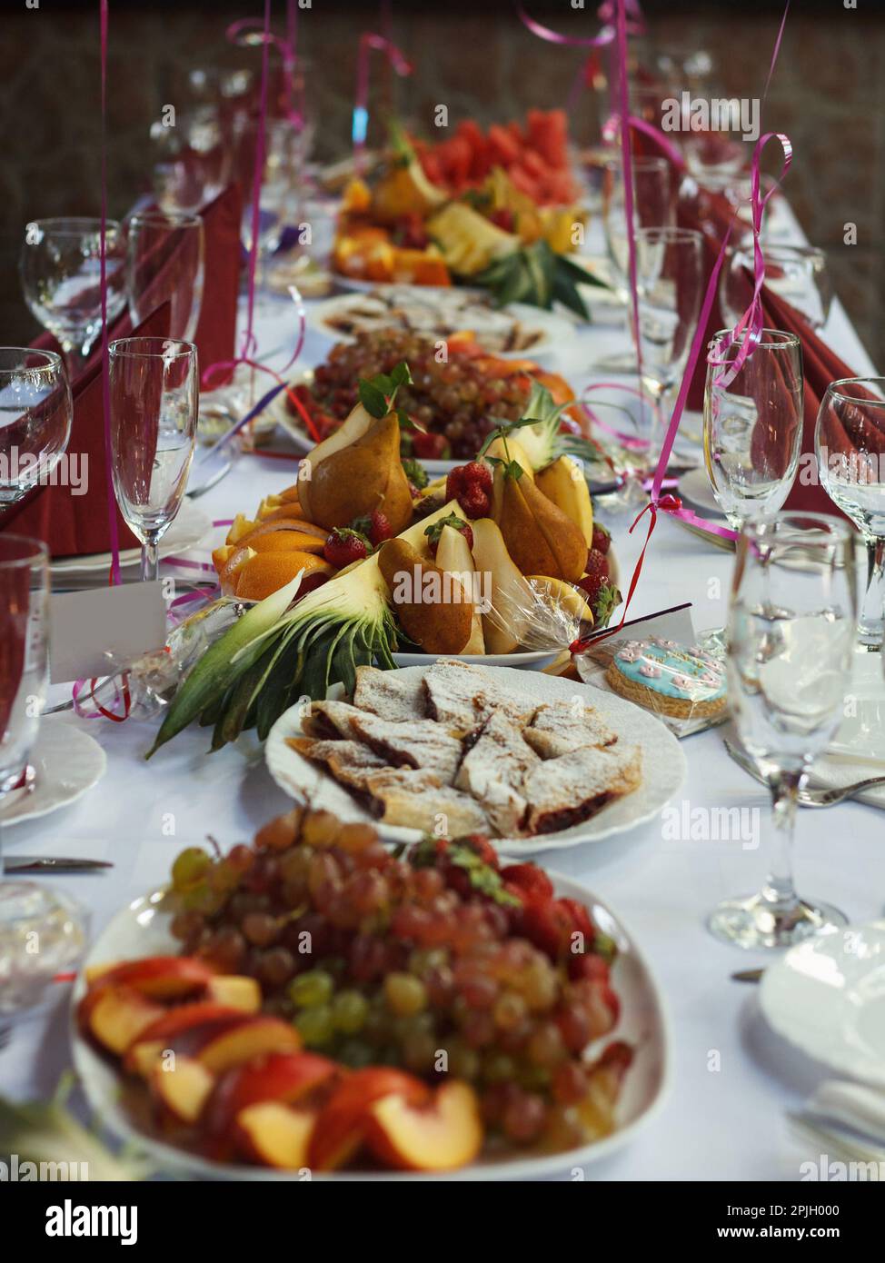 Festive banquet table with dessert food in restaurant Stock Photo
