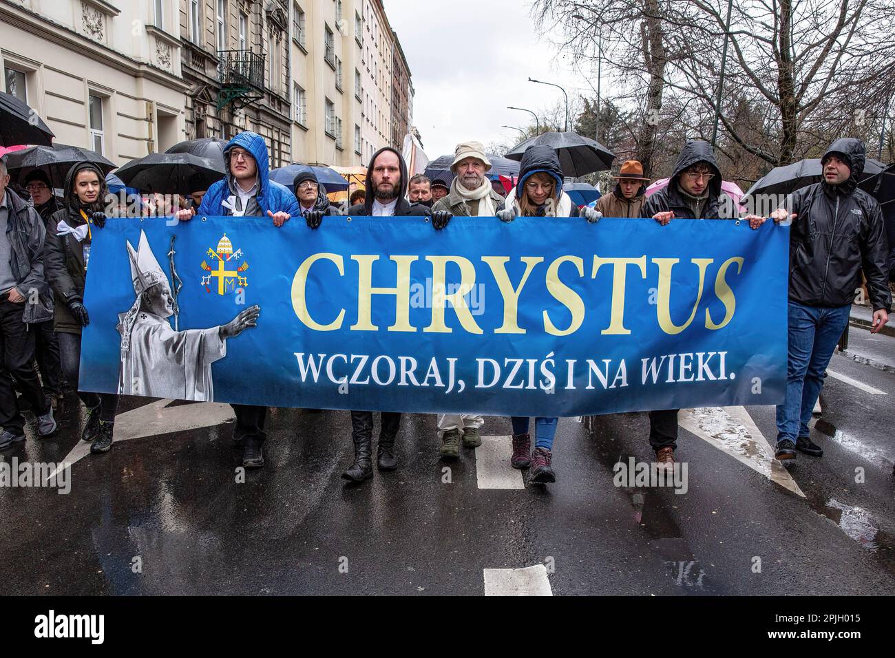 thousands-of-people-hold-a-banner-as-they-participate-in-a-white-papal