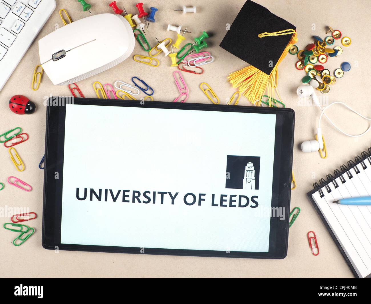 In this photo illustration, the University of Leeds logo seen displayed on a tablet. Stock Photo