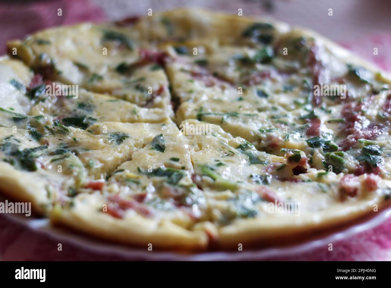 tasty magnificent omelet with greens and sausage for breakfast close up Stock Photo