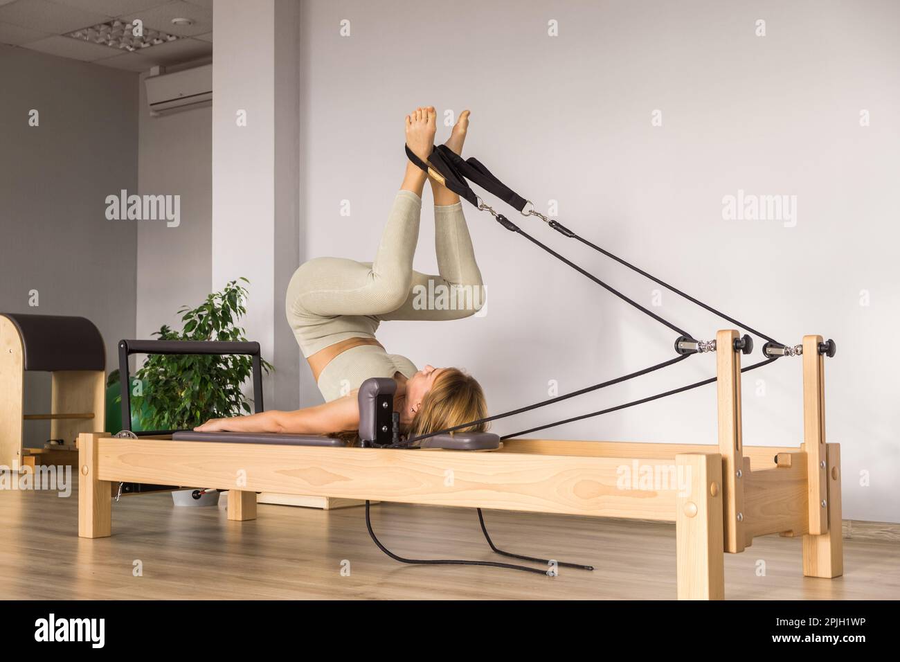 Woman training pilates on the reformer bed. Reformer pilates studio machine  for fitness workouts in gym. Fit, healthy and strong authentical body Stock  Photo - Alamy