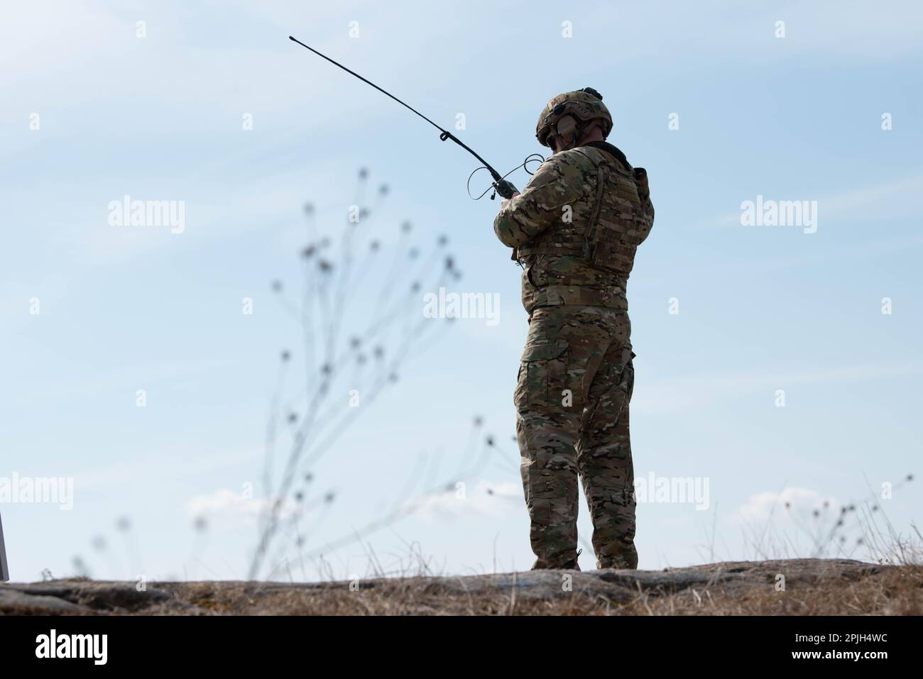 A Tactical Air Control Party (TACP) airman sets up a radio while