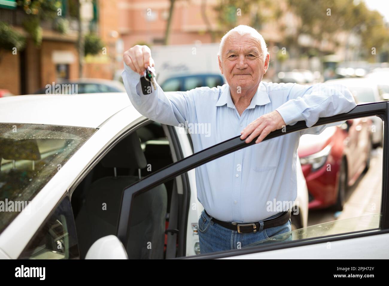 Old man standing beside car Stock Photo - Alamy