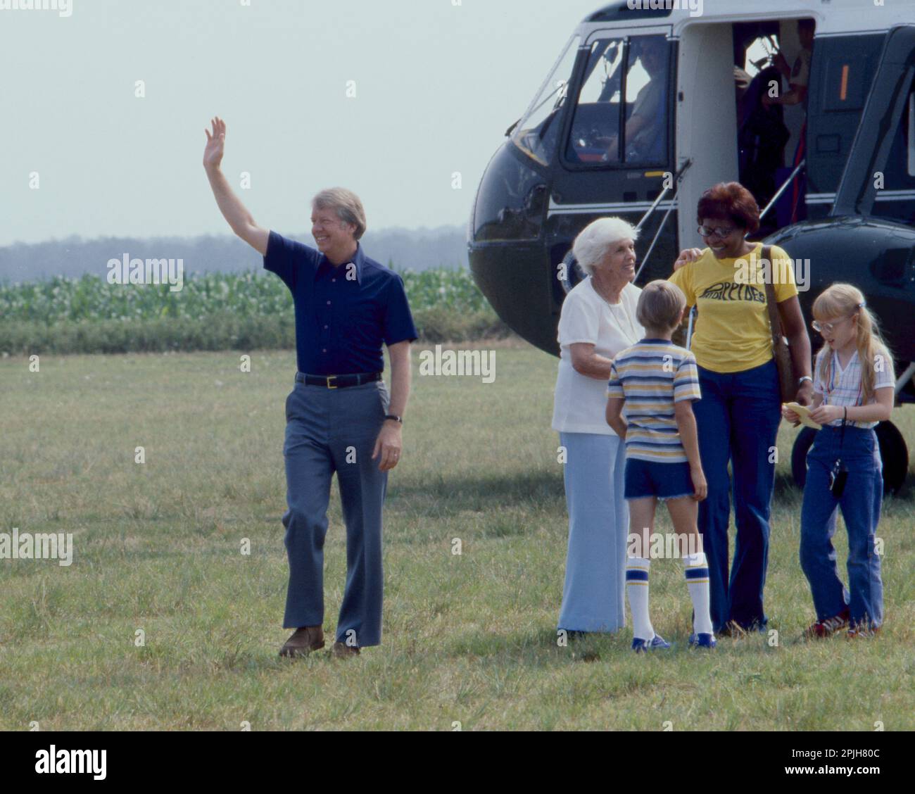 President Jimmy Carter disembarks Marine One - arriving in Plains, GA. With the President is his mother, Lillian Carter, a young friend of Amy's (back toward camera), daughter Amy, accompanied by her nanny, Mary Prince. Ms. Prince, a black woman, -once convicted of murder in Georgia - was assigned to work as a trustee at the Georgia governor's mansion in a work-release program. Governor Carter became acquainted with Ms. Prince and was firmly convinced that she was innocent of the murder charge. Carter later applied to be Ms. Princes' parole officer so that she could come to the White House to Stock Photo