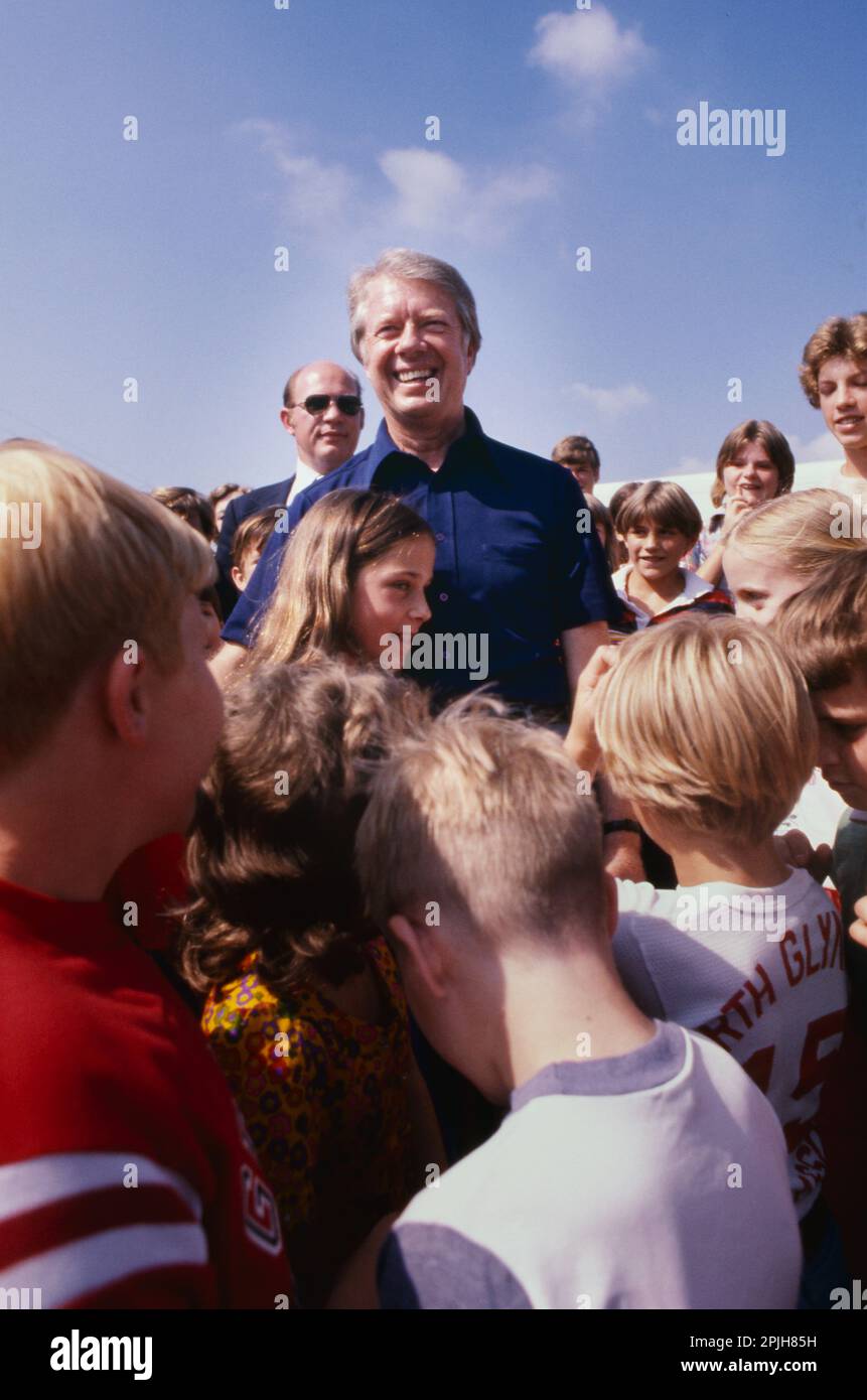 While driving in a motorcade to a vacation home in Georgia's Golden Isles, President Jimmy Carter saw children lining the roadway to get a peek at the president. Carter ordered the motorcade stopped and the children swarmed to him. - To license this image, click on the shopping cart below - Stock Photo
