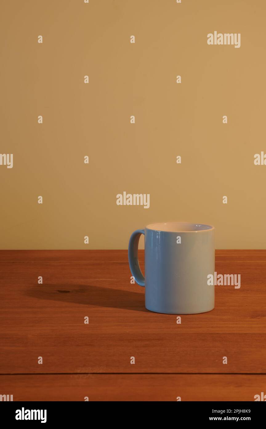 Blue mug on an empty wooden table Stock Photo