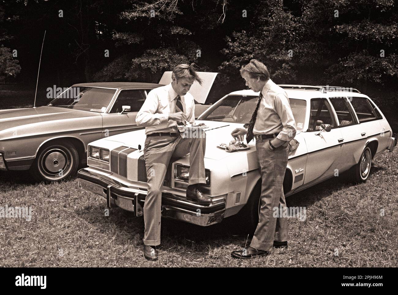Carter and Mondale get away from the crowd for a privatetalk while attending a church picnic at Plains Baptist. Stock Photo