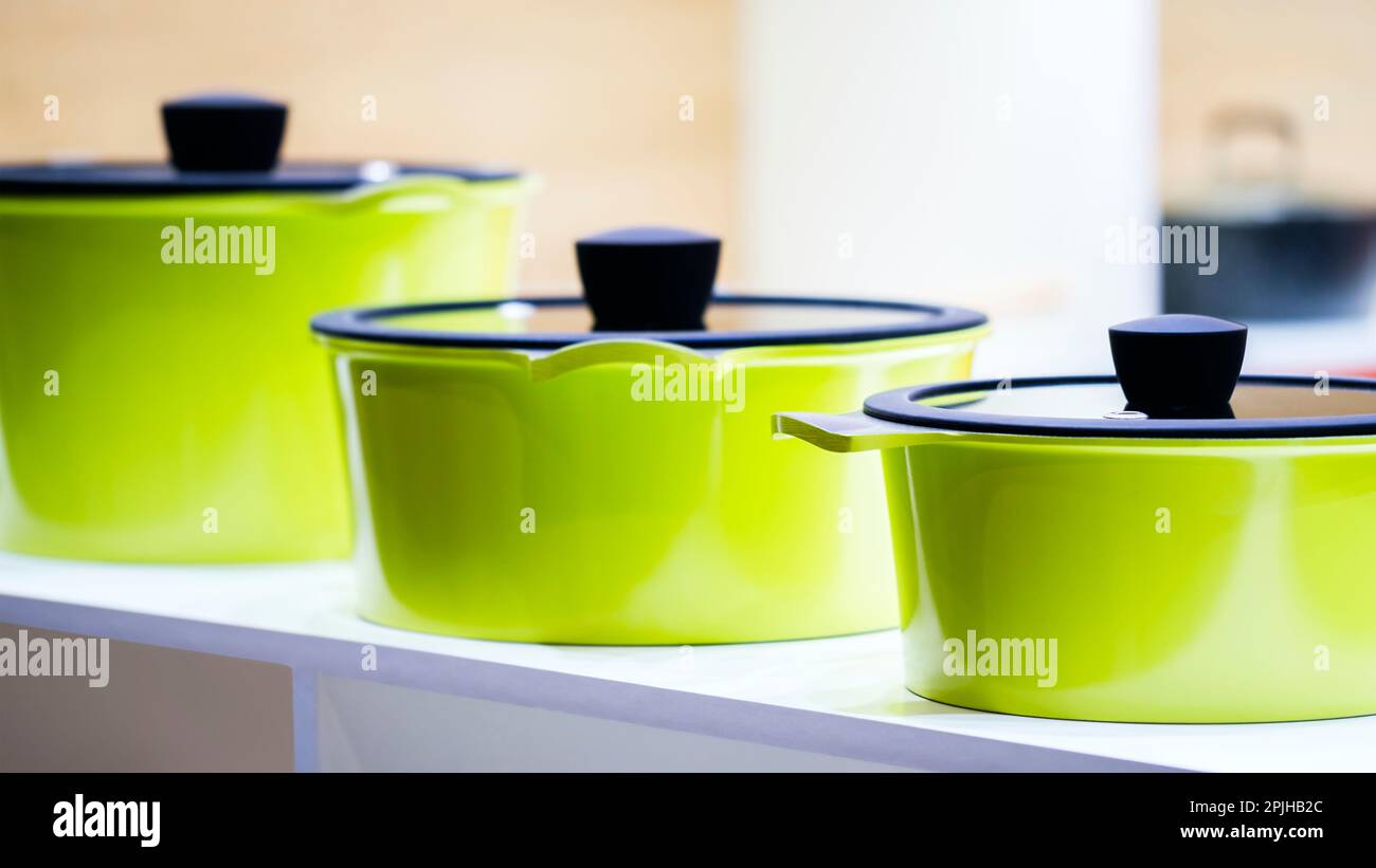 Yellow green saucepans in the kitchen closeup Stock Photo Alamy