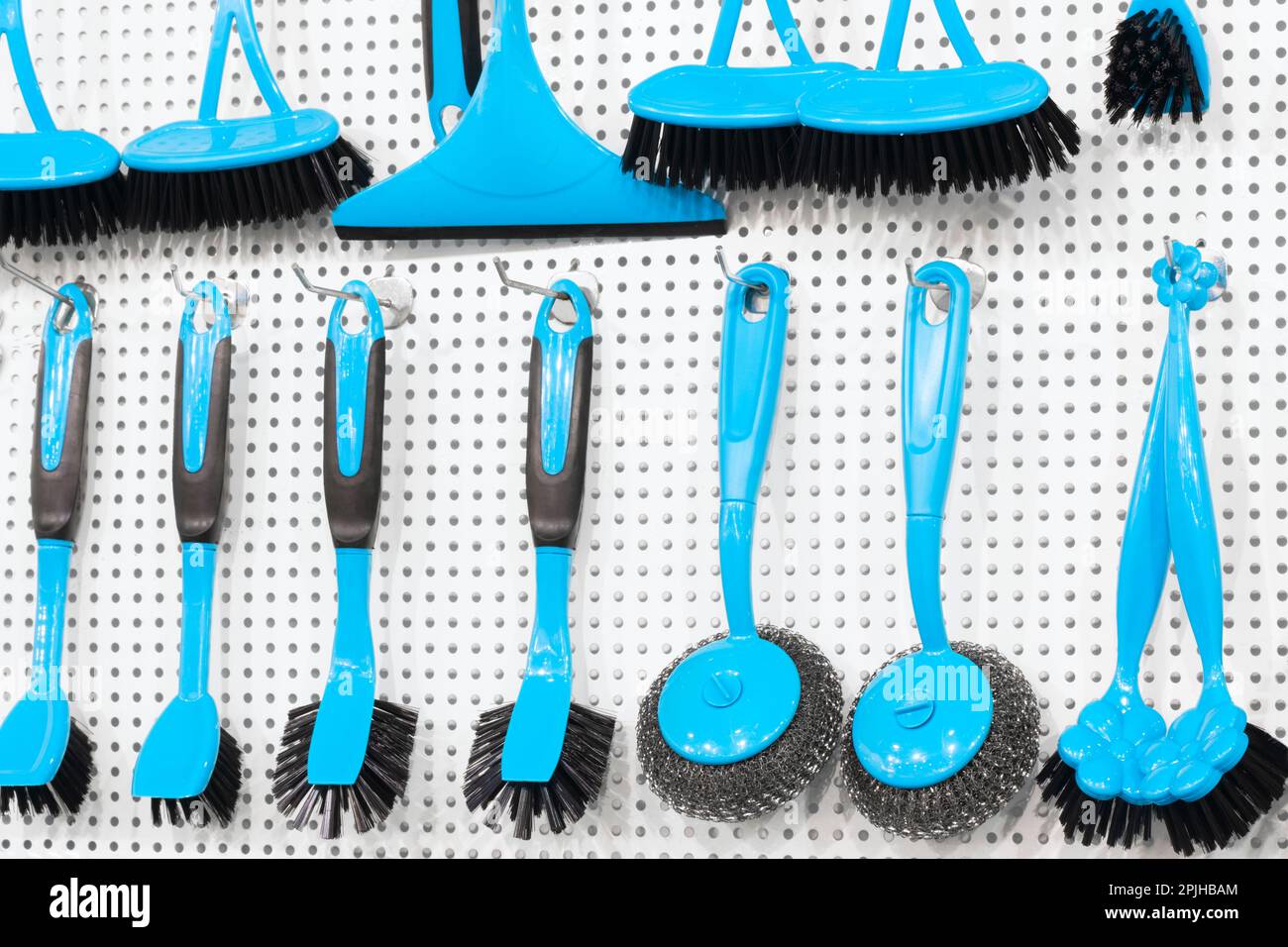 kitchen brushes hang in supermarket Stock Photo