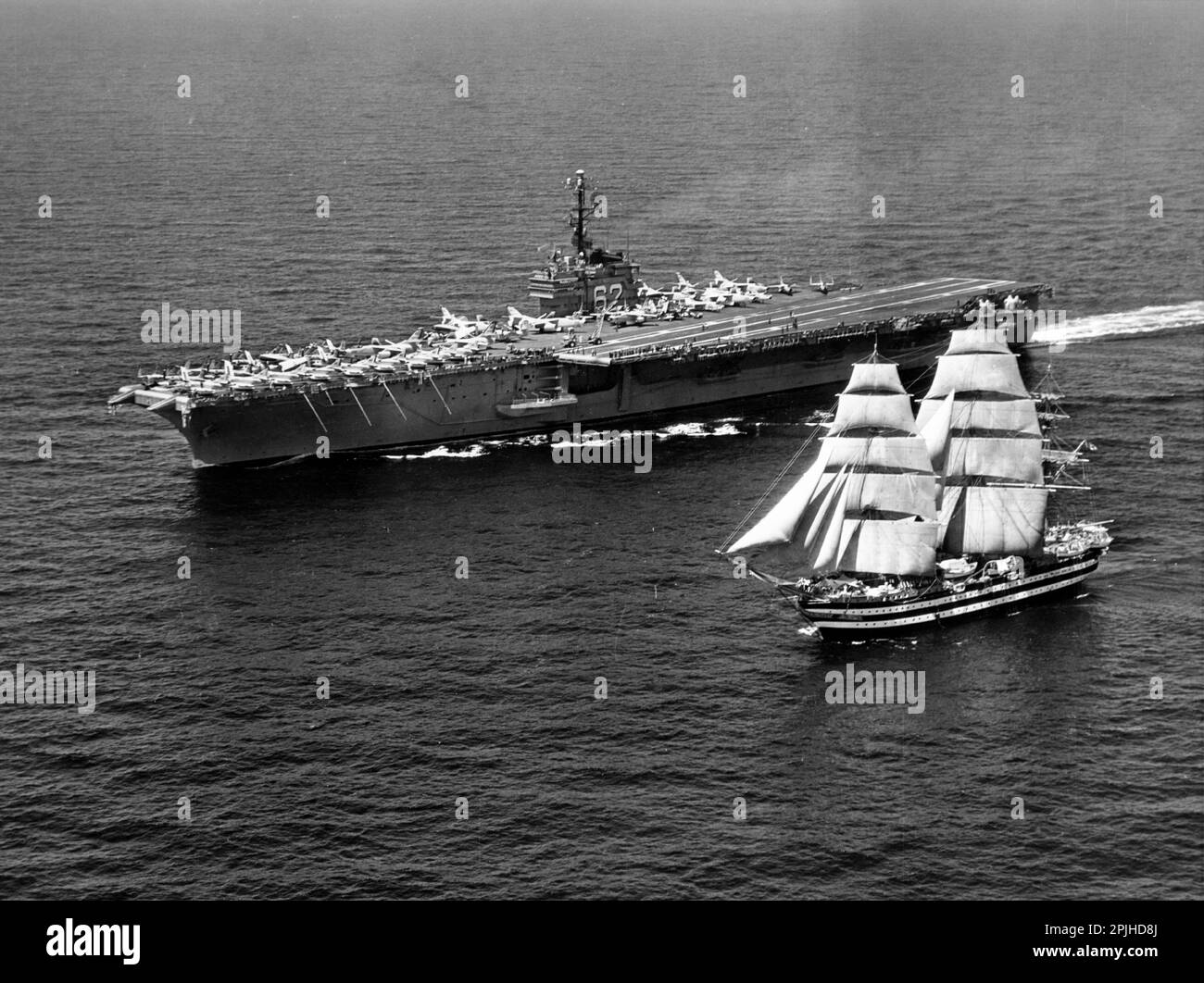 The U.S. Navy aircraft carrier USS Independence (CVA-62) underway with the Italian Marina Militare training ship Amerigo Vespucci on 12 July 1962. Independence, with assigned Carrier Air Group 7 (CVG-7), was deployed to the Mediterreanean Sea from 19 April to 27 August 1962. Stock Photo