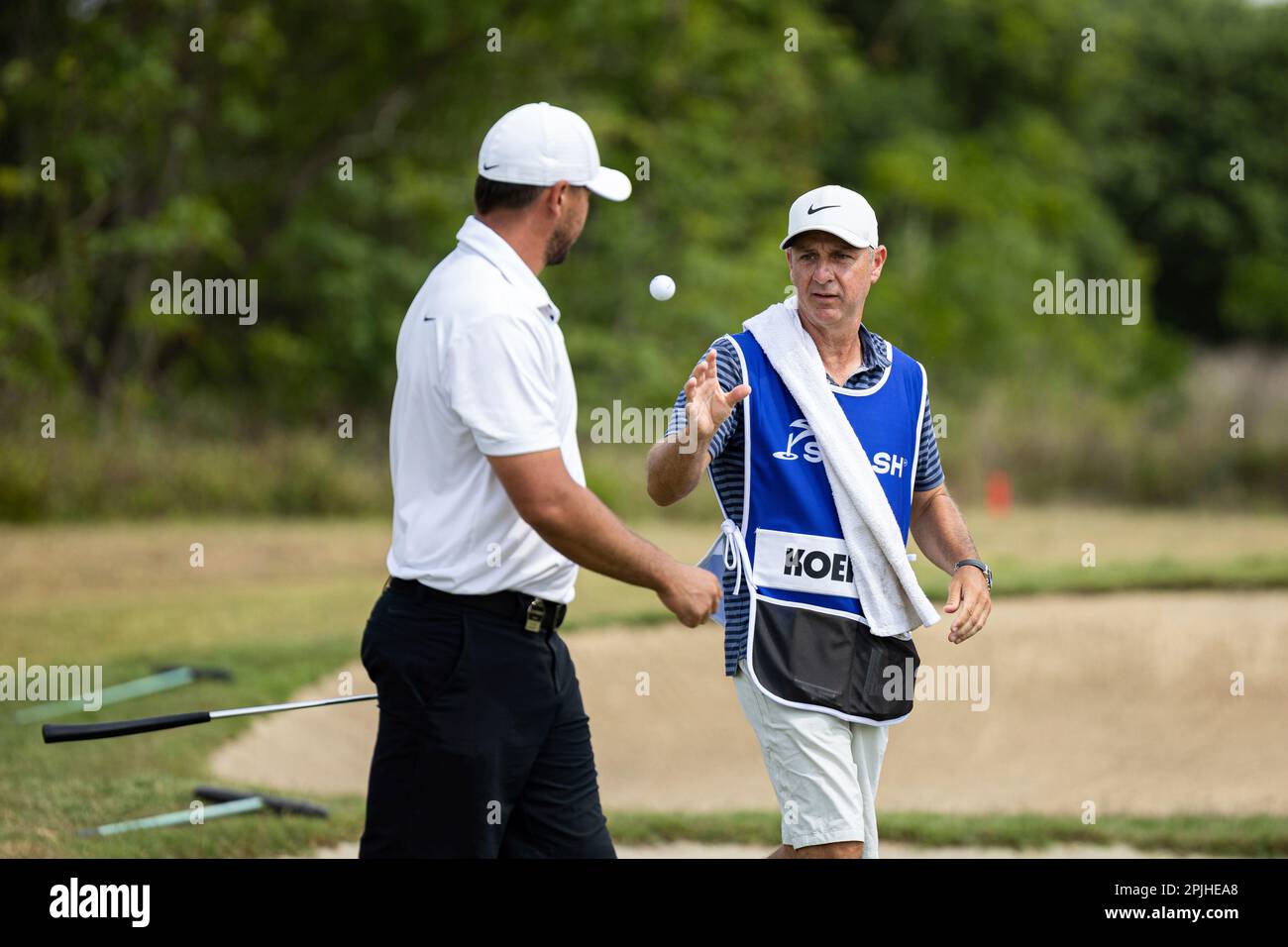 Captain Brooks Koepka of Smash GC caddie throws him a golf ball on the
