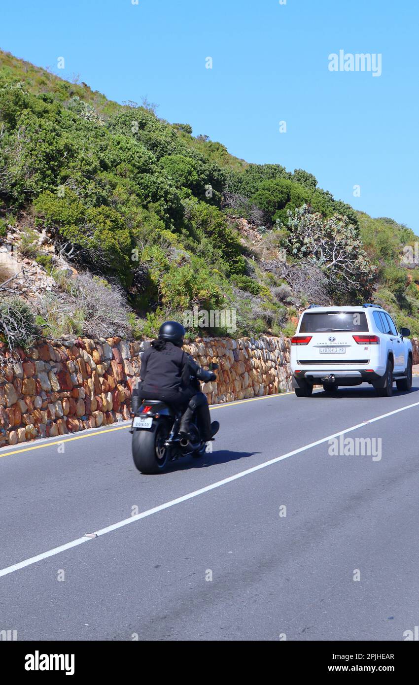 motorcycles driving on a road in a mountain , Gordon's bay Cape Town