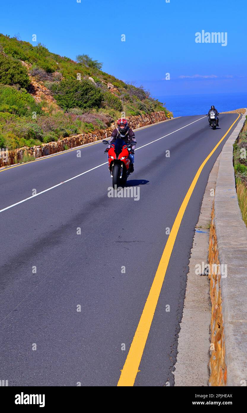 motorcycles driving on a road in a mountain , Gordon's bay Cape Town