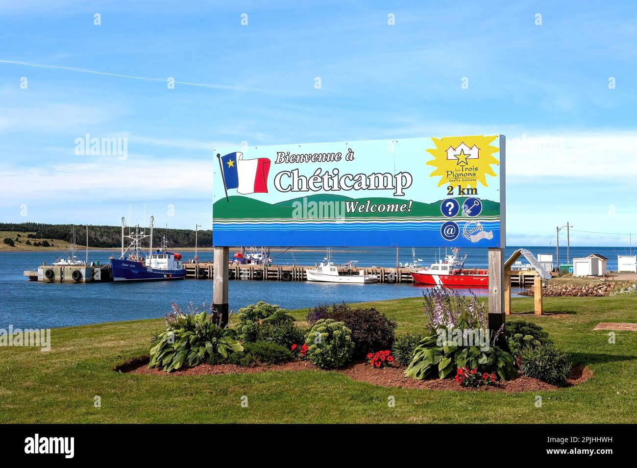 Cheticamp, Canada - August 3, 2011: Sign welcoming people to Cheticamp on the Cabot Trail of Cape Breton, Nova Scotia. The fishing village is mainly p Stock Photo