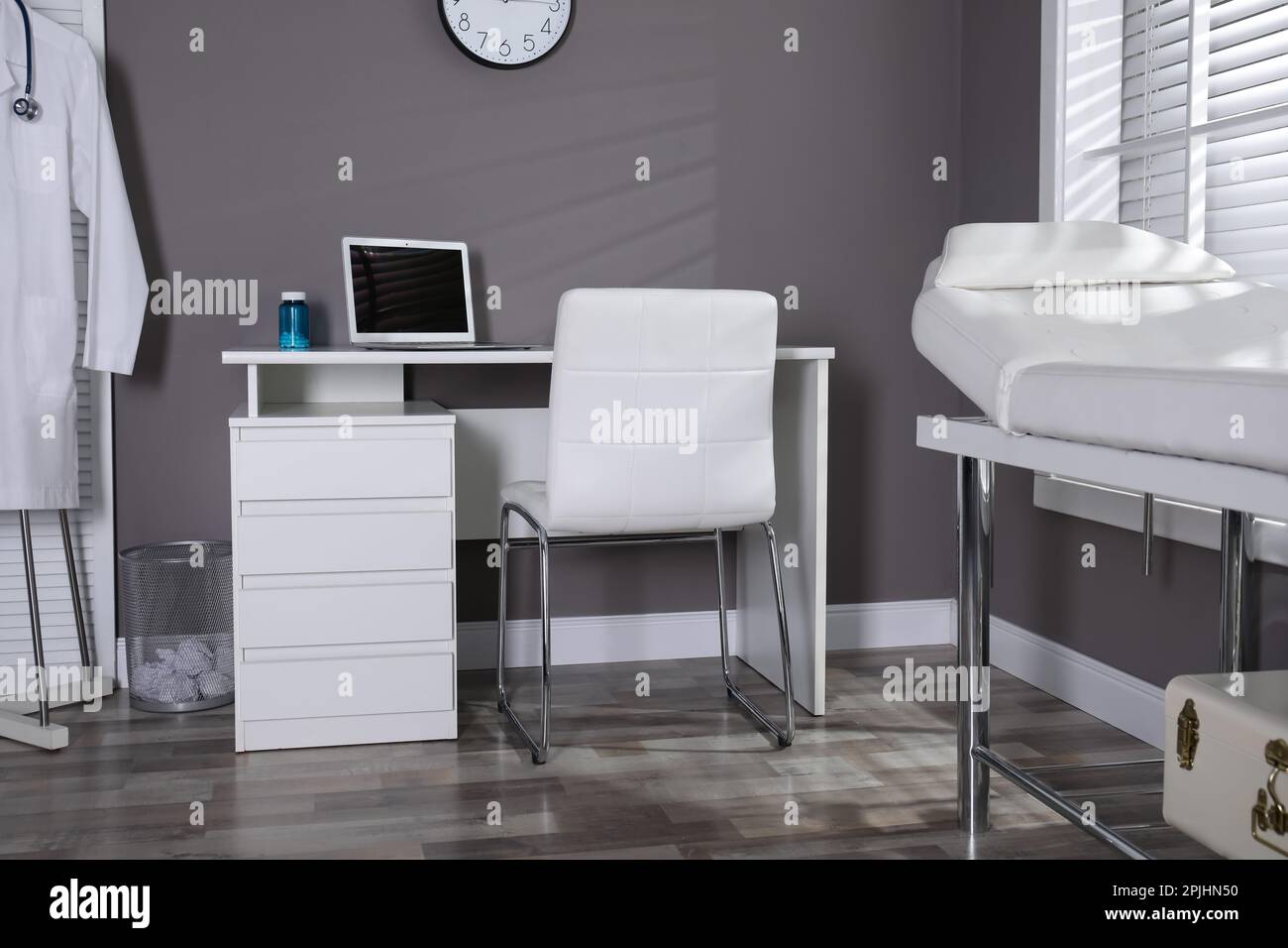 Modern medical office interior with doctor's workplace and examination ...
