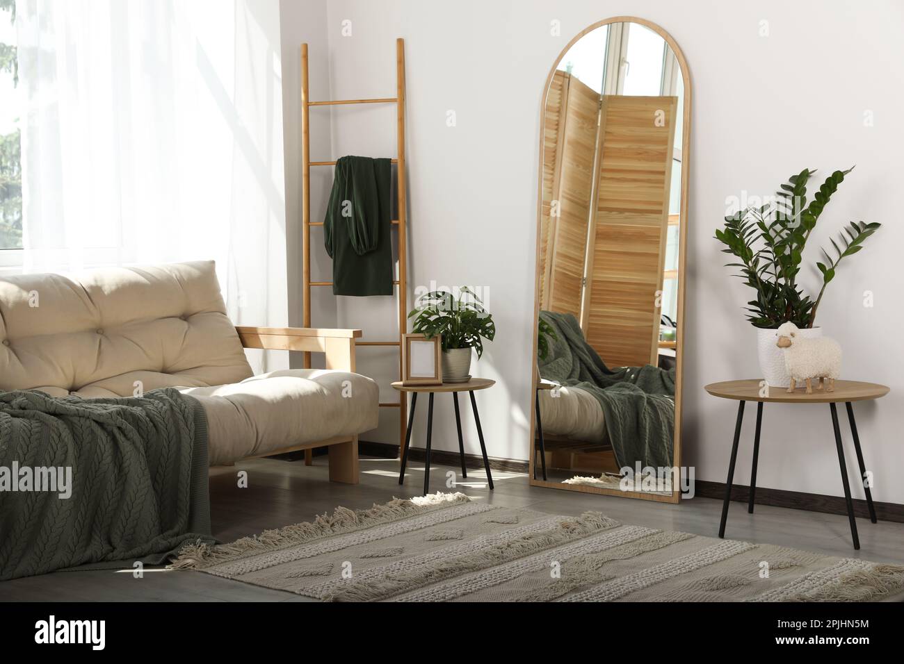 Stylish room interior with leaning floor mirror Stock Photo Alamy