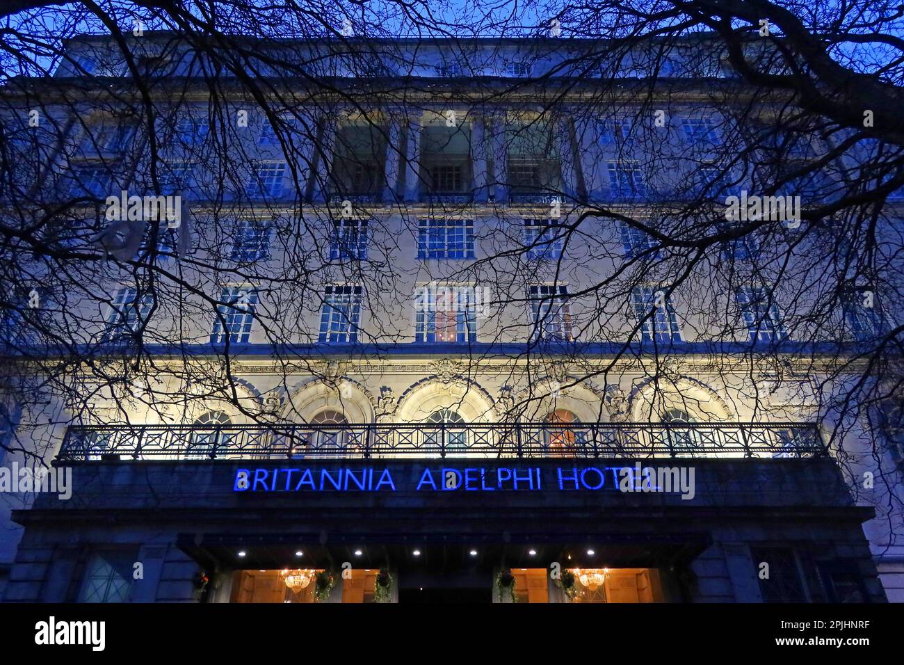 Dusk view of the Britannia Adelphi Hotel with illuminated signage and lit entrance, Liverpool city centre, Merseyside, England, UK. Stock Photo