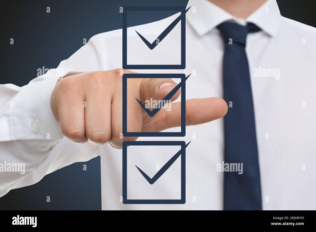 Man pointing at check boxes with marks on virtual screen, closeup Stock ...