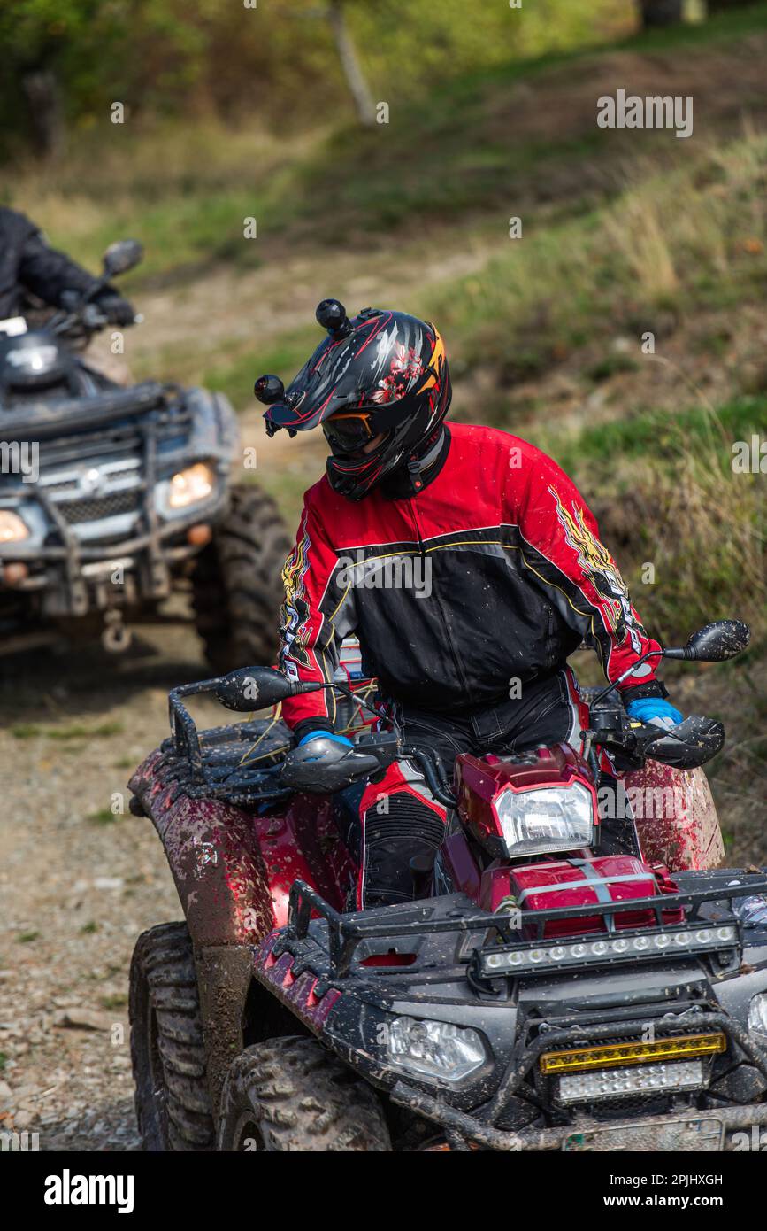 Adventurous driving of ATV motorbikes. A man drives a quad bike on