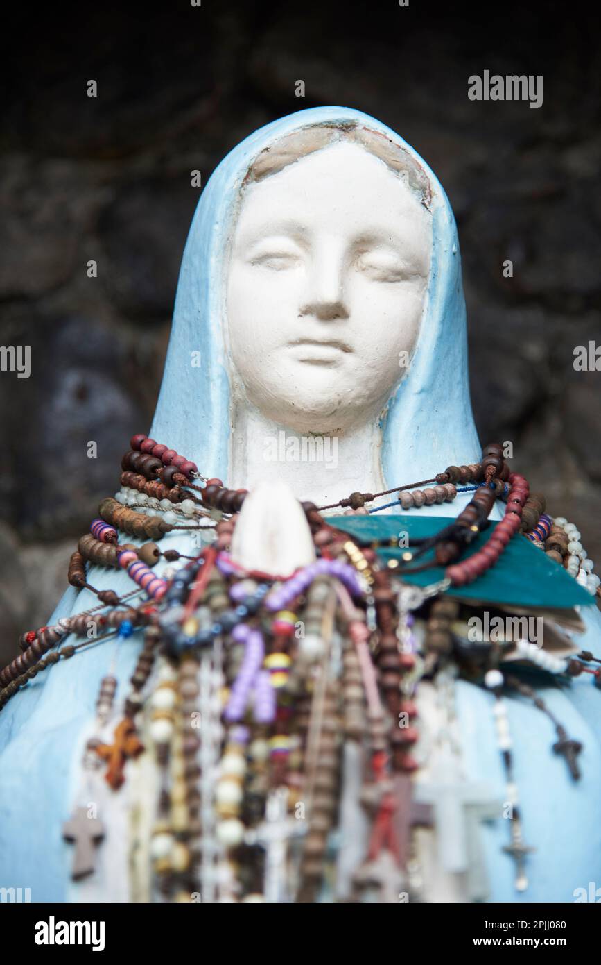 Nov 21, 2023, Puente Nacional, Santander, Colombia: Statue of the Virgin located outdoors with many rosaries hanging from her neck and hands. Concept: Stock Photo
