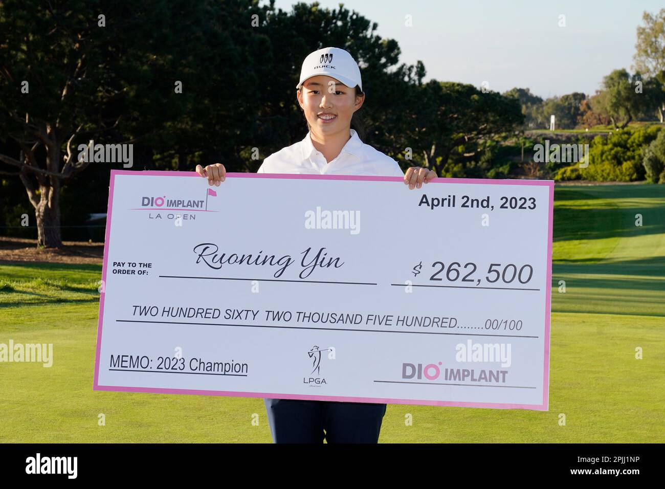 Ruoning Yin holds a check that she was awarded after winning the LPGA's