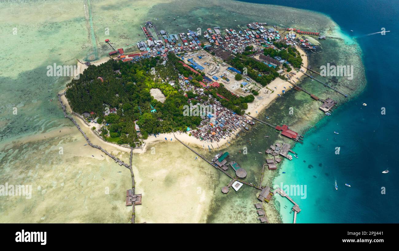 Aerial view of tropical island Mabul in the blue sea with a coral reef and the beach. Semporna, Sabah, Malaysia. Stock Photo