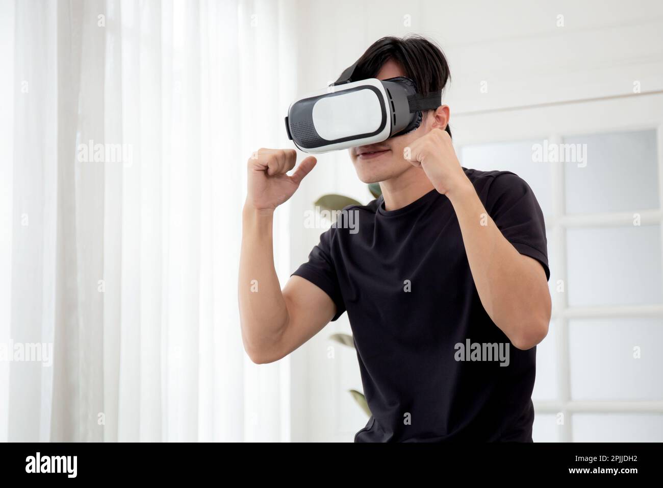 Young asian man wearing vr headset while workout and exercise at living