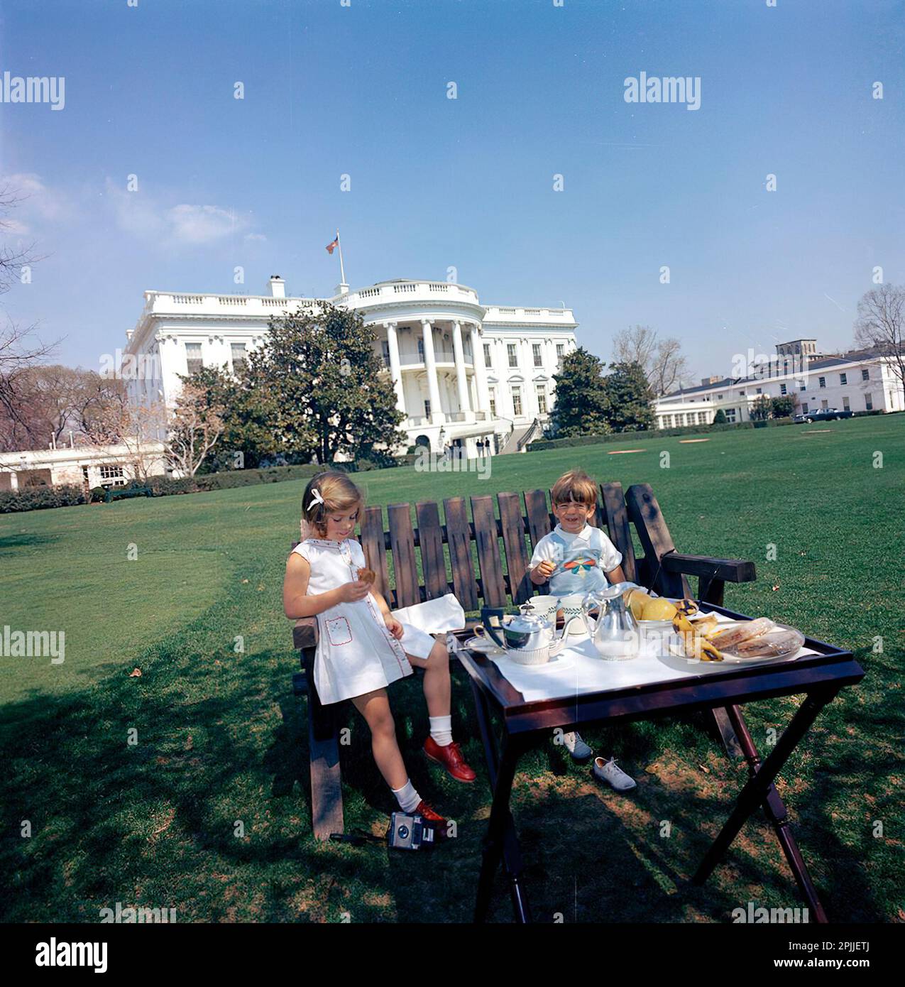 ST-C66-12-63                   1 April 1963 President Kennedy with Caroline Kennedy (CBK) & John F. Kennedy, Jr. (JFK, Jr.), on the South Lawn. [Scratching throughout negative.]  Please credit 'Cecil Stoughton. White House Photographs. John F. Kennedy Presidential Library and Museum, Boston' Stock Photo
