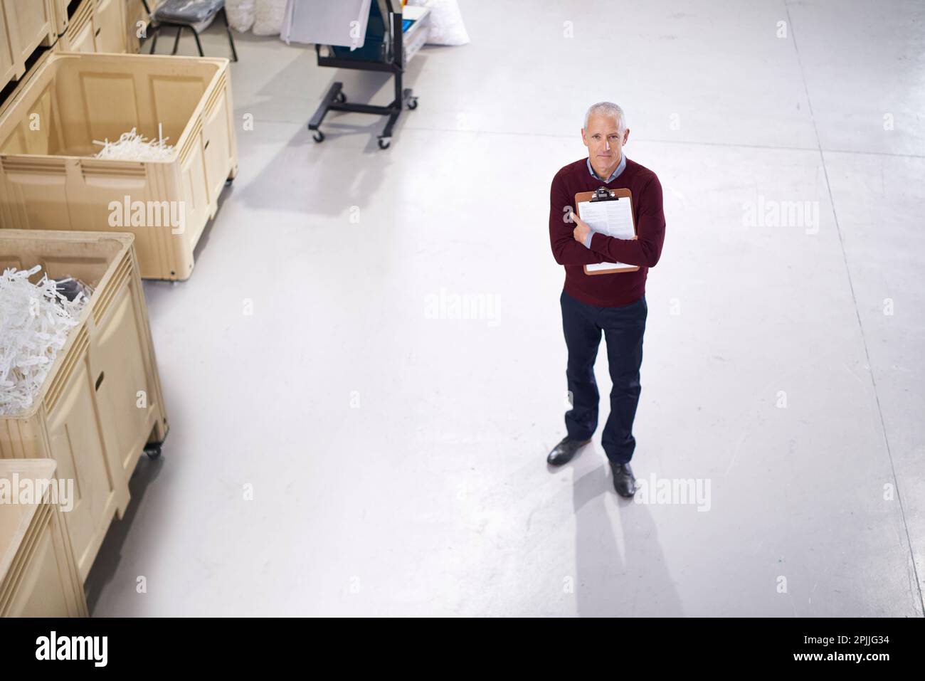 Inspections are done at regular intervals. Portrait of a factory manager standing with a clipboard. Stock Photo