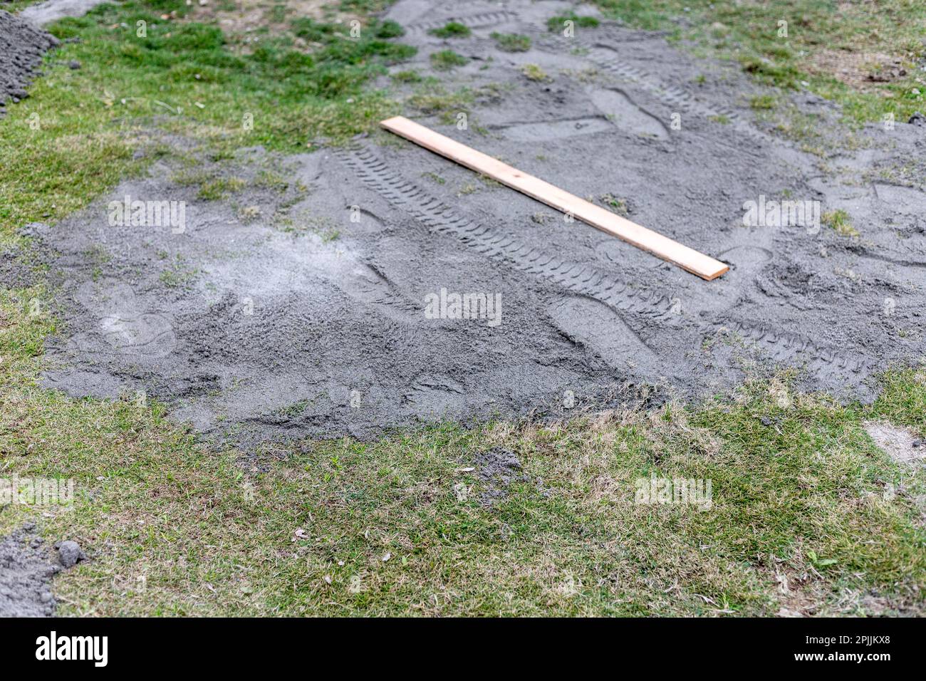 Using a sand to level the lawn at home Stock Photo Alamy