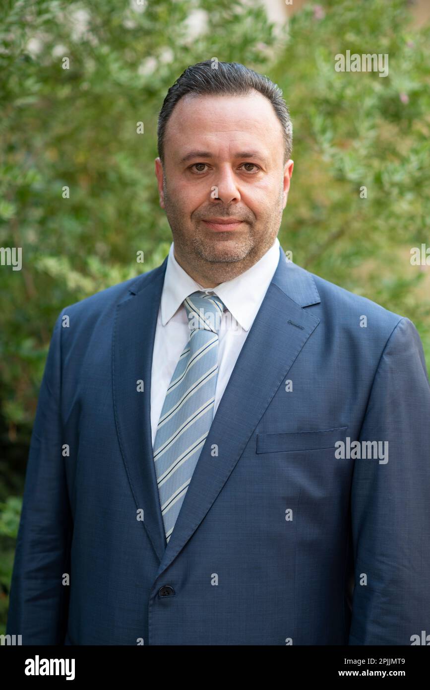 Man in suit looking at camera outdoors Stock Photo