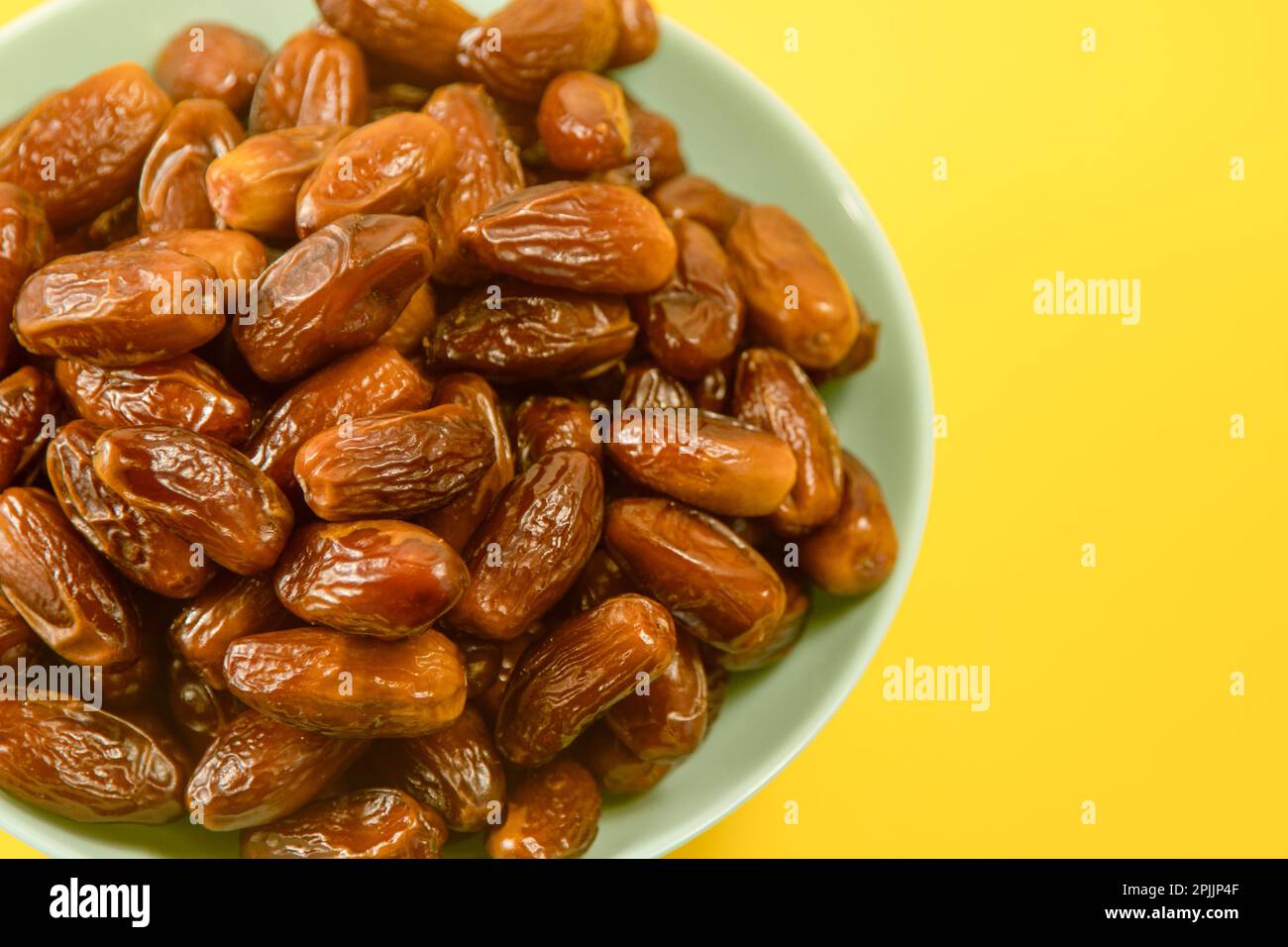 Dates. Dried date palm fruits. Healthy sweet snack food bowl. Pile of