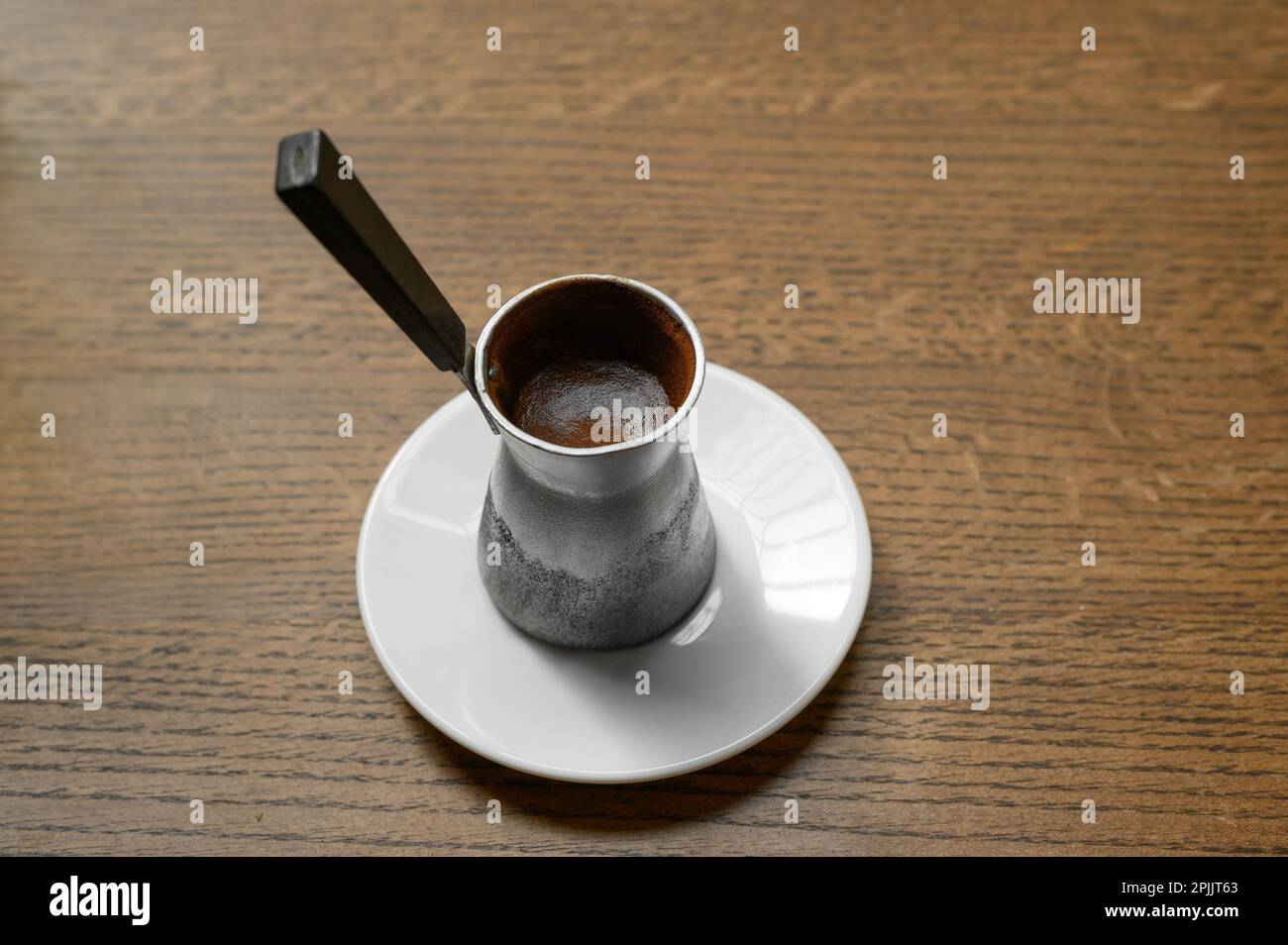 Jezve with fresh coffee on wooden table Stock Photo Alamy