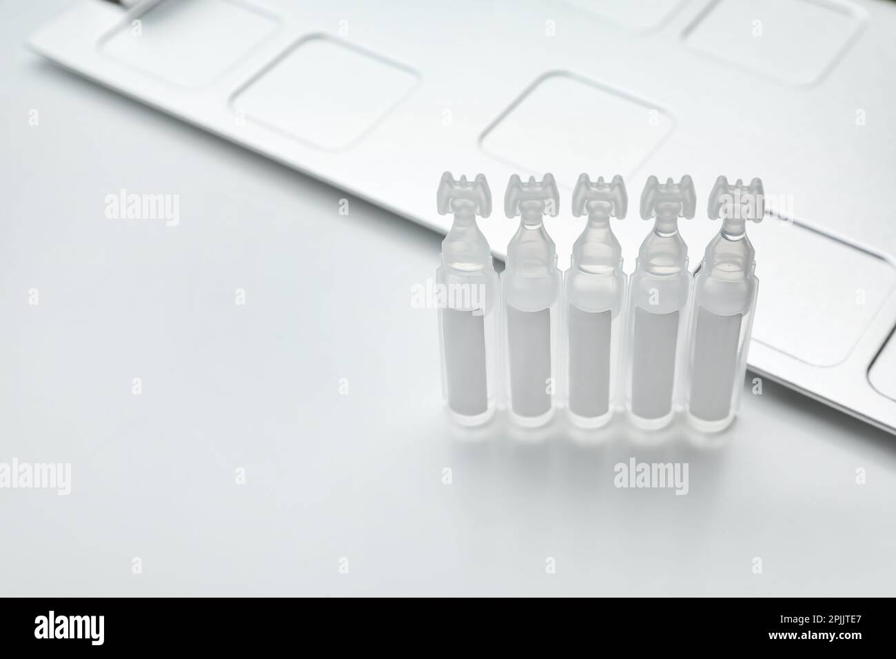 Single dose ampoules of sterile isotonic sea water solution on white