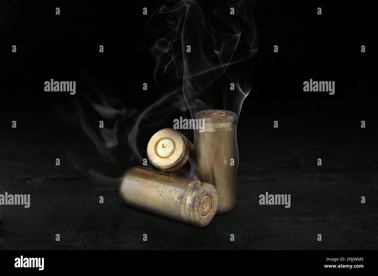 Cartridge cases with smoke on black background Stock Photo Alamy