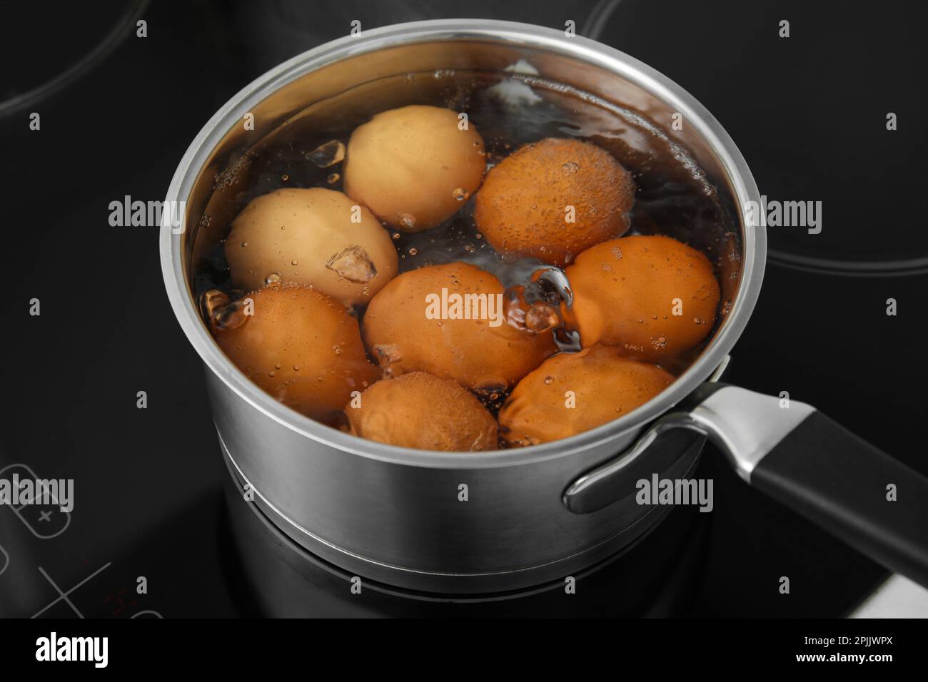 Boiling chicken eggs in saucepan on electric stove Stock Photo Alamy