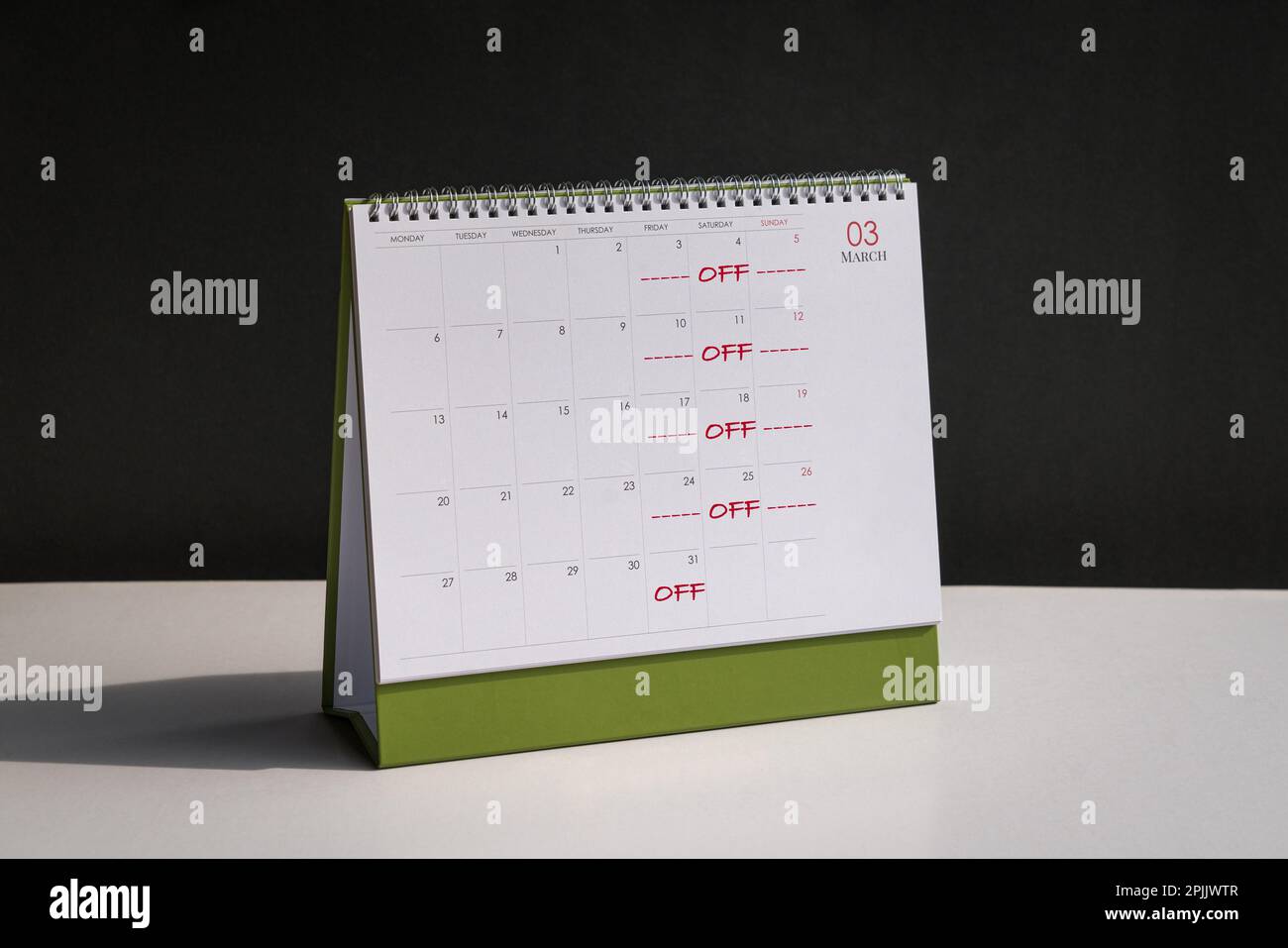 Red color words, Off Day on Fridays, Saturdays and Sundays printed on desk calendar. Four day work week concept. Stock Photo